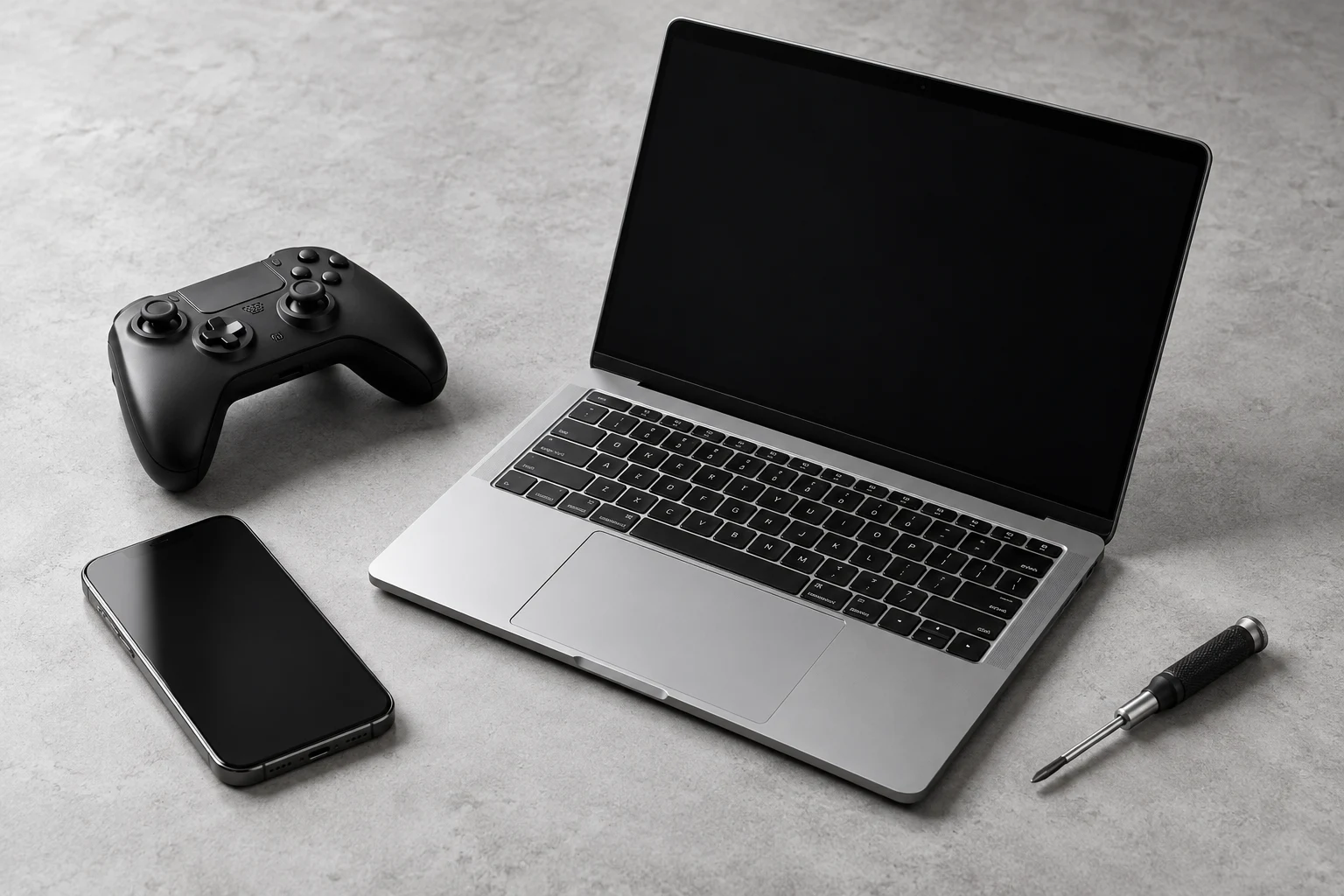 Laptop, phone, controller and repair tool in a monochrome hardware still-life